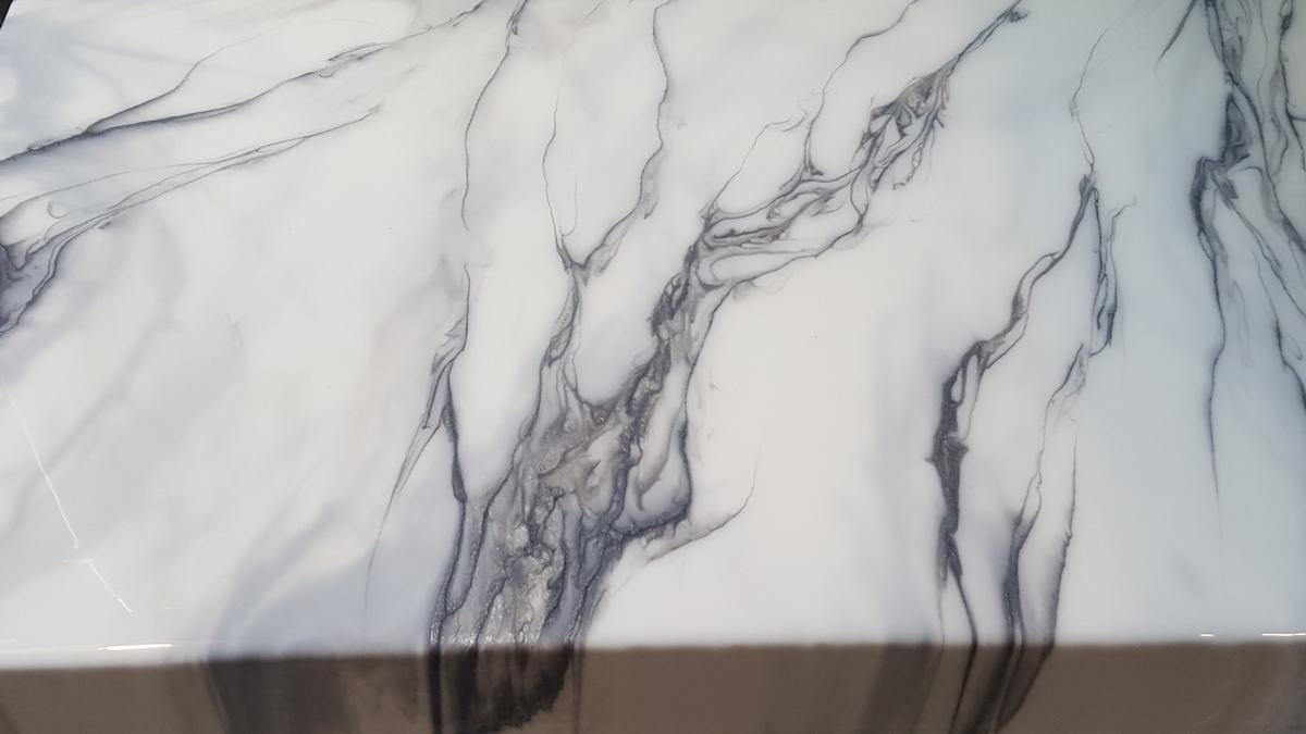 Hand-poured faux carrara style white marble epoxy countertop over a client's DIY concrete countertop in Beaverton Oregon. Titanium and gunmetal veining/accents.